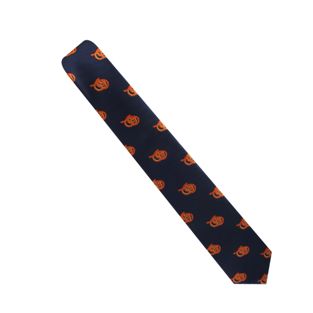 The Pretzel Skinny Tie features a navy design with an evenly spaced pattern of orange jack-o'-lantern faces, adding a twist of charisma to your attire.