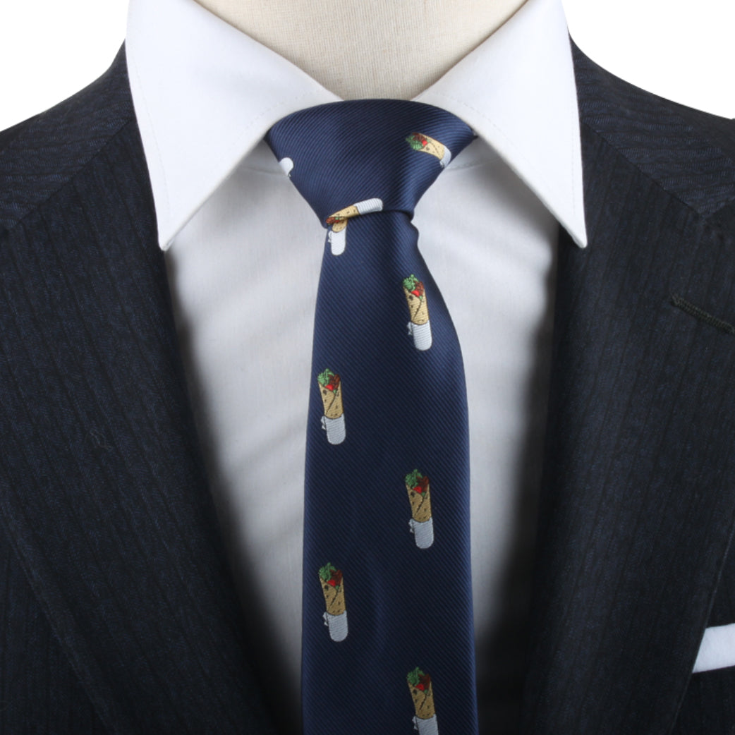 Close-up of a person wearing a dark suit and a white dress shirt, accessorized with the Kebab Skinny Tie, which features a burrito pattern that captures the essence of quirky elegance.