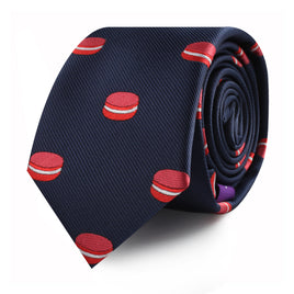 A rolled-up Macaroon Skinny Tie in navy blue with red macaron patterns exudes a touch of elegance.