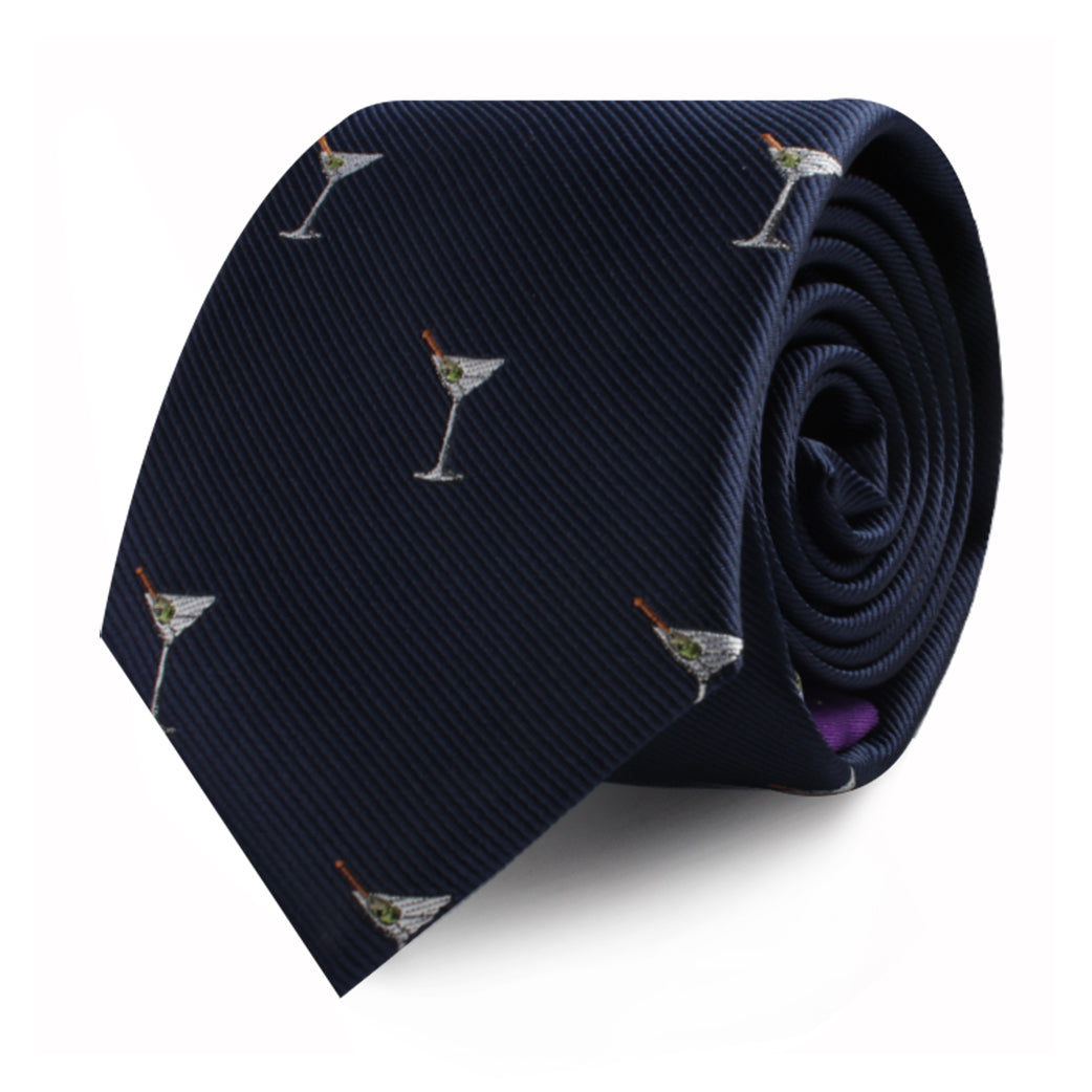 The Martini Skinny Tie is a dark blue necktie adorned with small embroidered martini glasses featuring green olives, adding a touch of classic class to any ensemble.