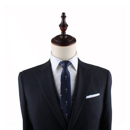 A mannequin dressed in a classic dark suit, white dress shirt, and the Martini Skinny Tie in navy blue with a white pattern.