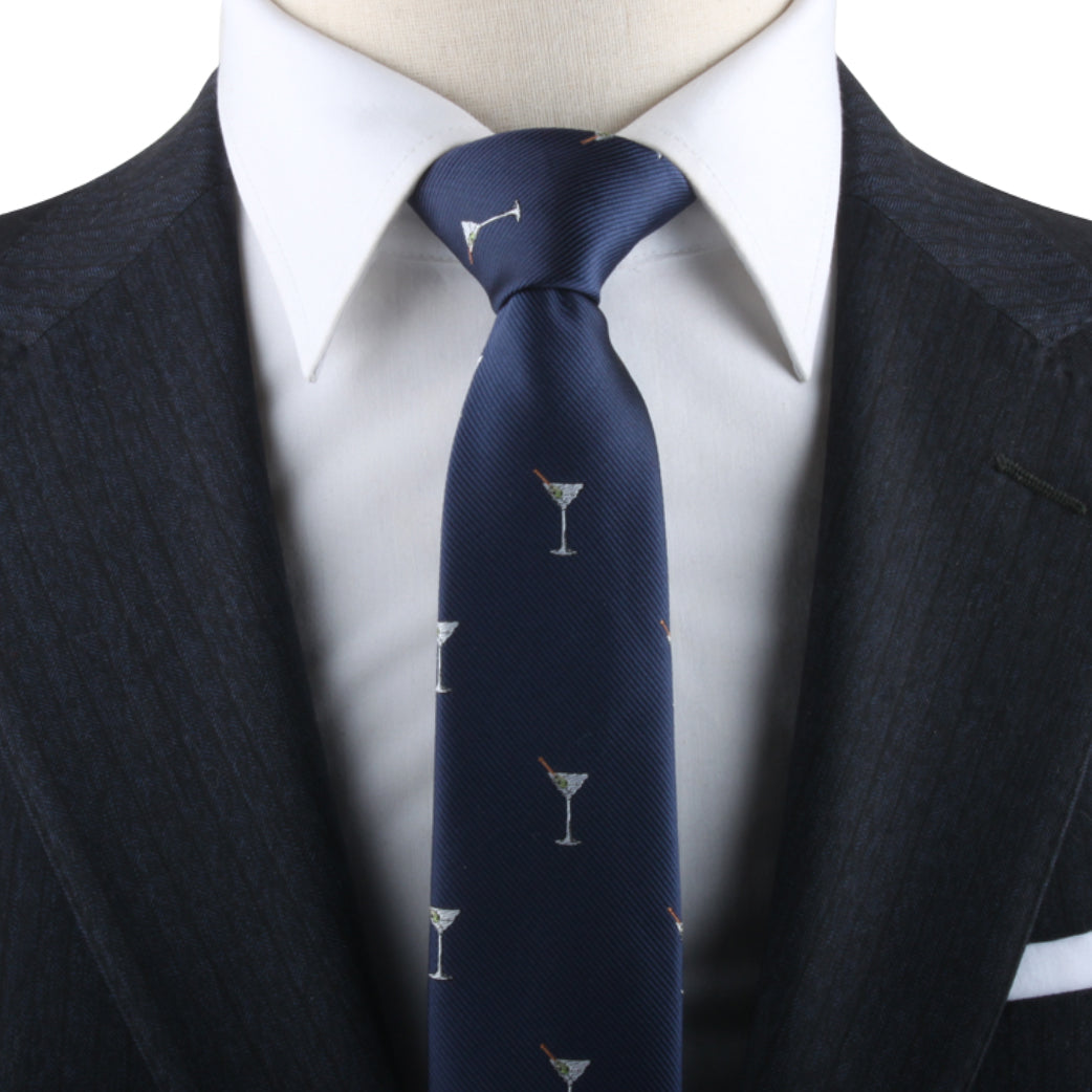 Close-up of a person wearing a white dress shirt, dark patterned suit jacket, and the Martini Skinny Tie featuring martini glass motifs, exuding a classic sense of style with contemporary flair.