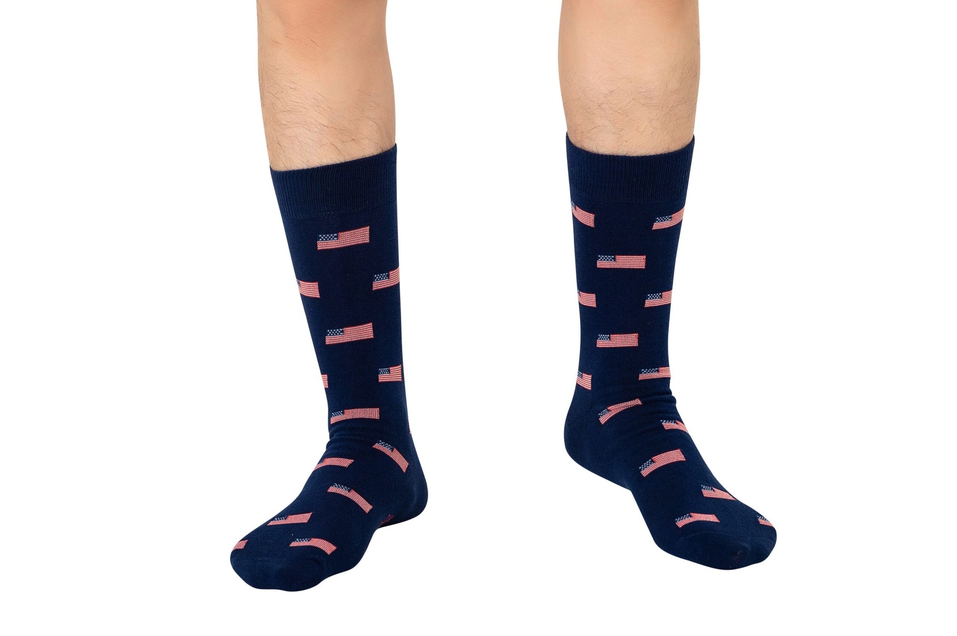 A person is wearing USA Flag Socks in navy blue, featuring small American flag designs with stars and stripes in a subtle yet stylish manner.