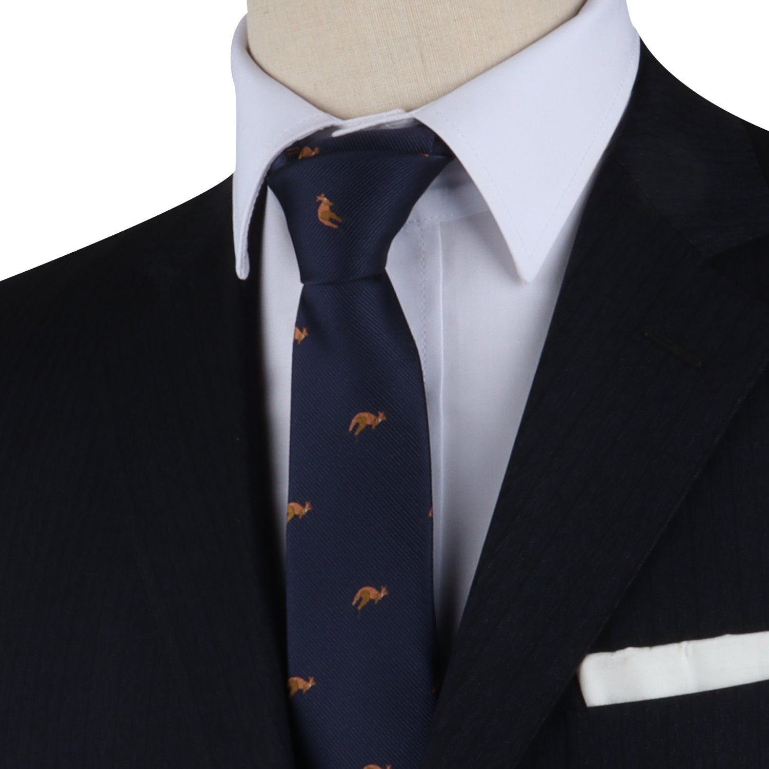 Close-up of a person wearing a dark suit, white shirt, and the Kangaroo Skinny Tie featuring small animal motifs, complemented by a white pocket square, showcasing unmatched elegance.