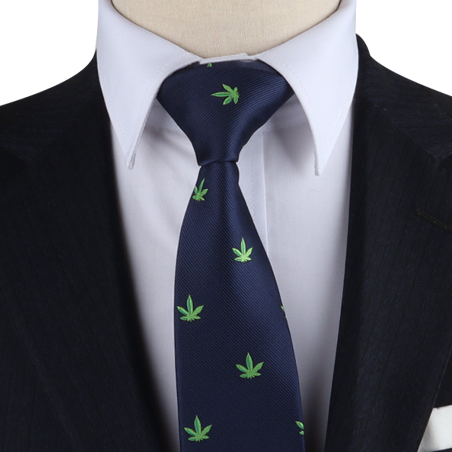 A person making a bold statement in a dark suit and white shirt, complemented by the laid-back Weed Skinny Tie featuring green cannabis leaf patterns on a navy blue background.