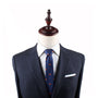 Mannequin dressed in a dark gray suit jacket, white shirt, and Goldfish Skinny Tie with red patterns that add artistic charm.