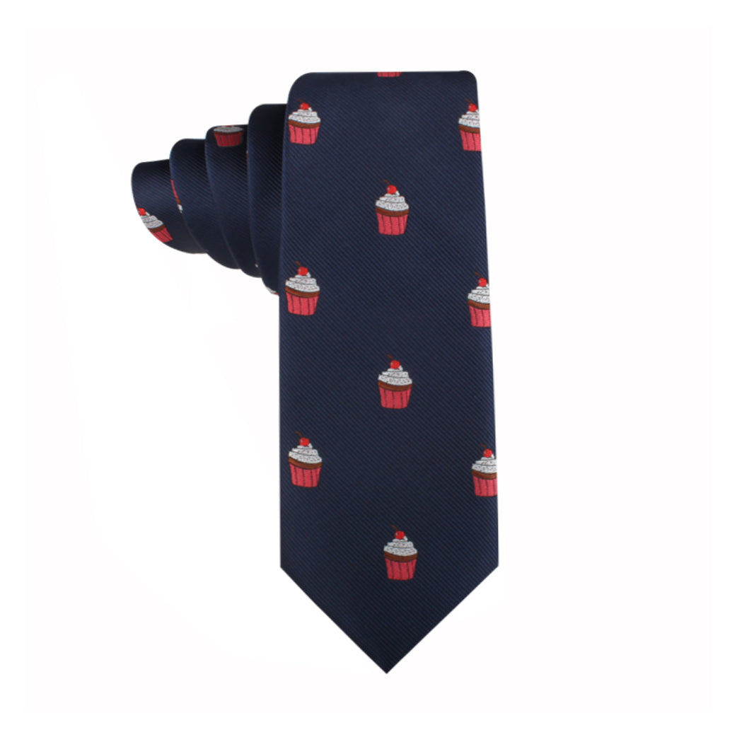 The Muffin Skinny Tie, featuring a delectable pattern of red and white cupcake illustrations on a navy background, makes for a unique style statement.