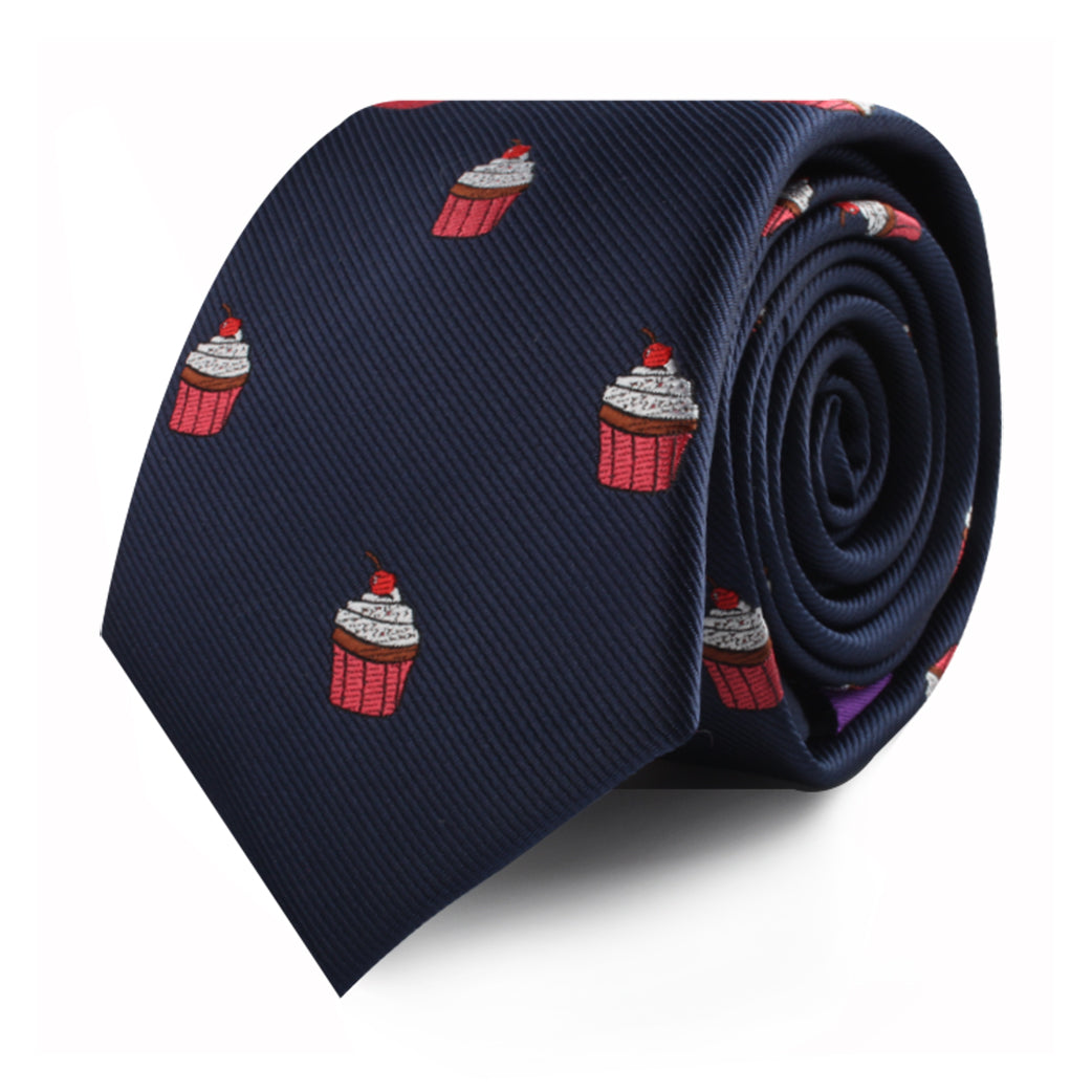 The Muffin Skinny Tie in navy blue, featuring a pattern of red cupcakes, makes a delectable style statement.