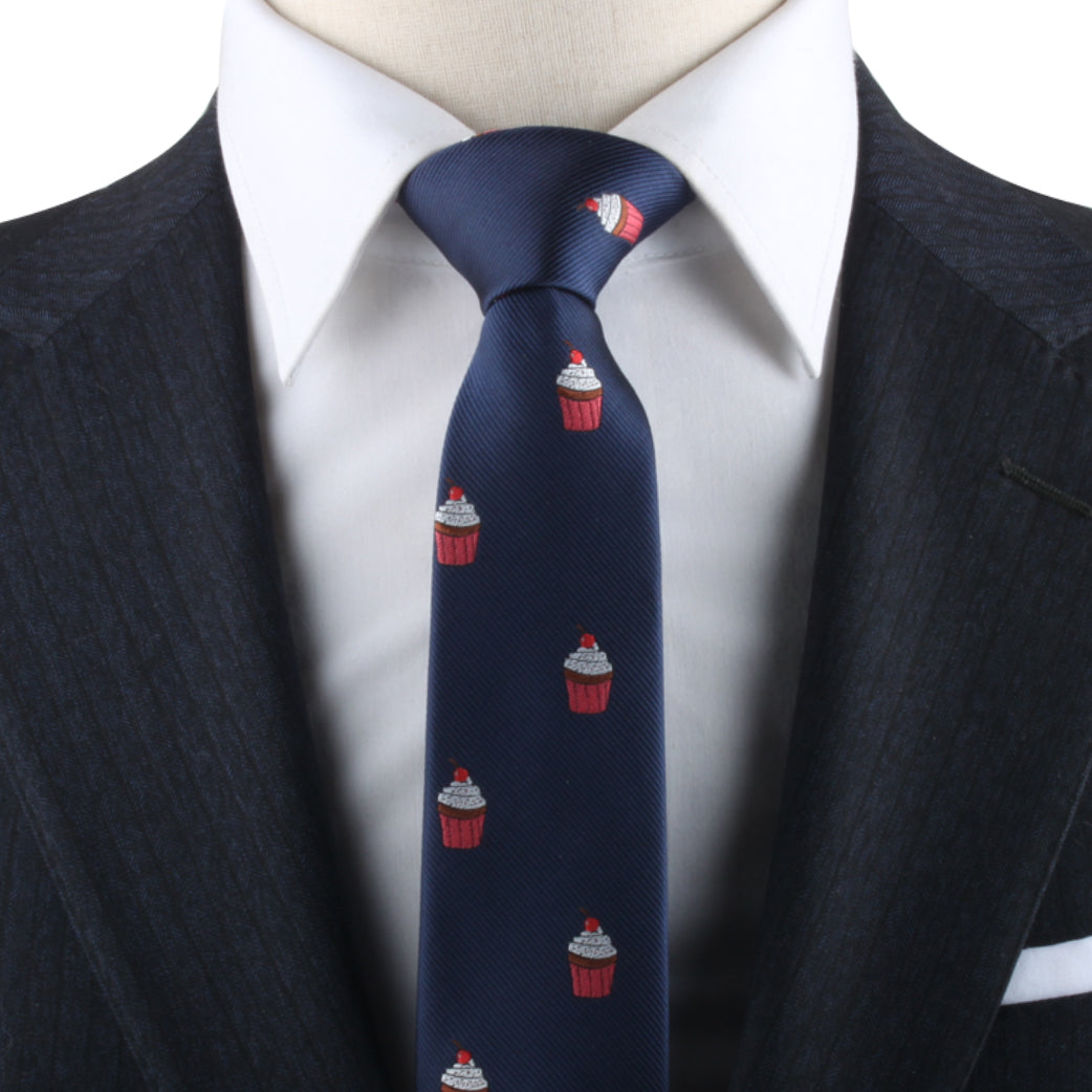 A dark blue suit and white dress shirt, complemented by the Muffin Skinny Tie with its playful small red and white cupcake patterns, make a delectable style statement.