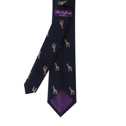 The Giraffe Skinny Tie is a dark blue necktie featuring small giraffe motifs and a purple label on the back adorned with the brand "Australian" in white text. This tie exudes sophistication, allowing you to stand tall with its subtle nod to a charming safari theme.