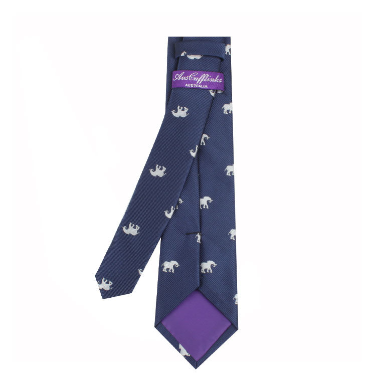 A blue Elephant Skinny Tie with a pattern of small white bears, exuding grace and charm. The label reads "Austen and Links" on a purple background.