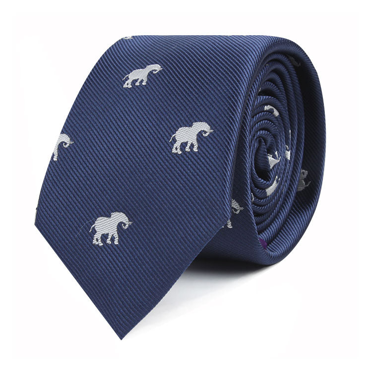 A rolled-up navy blue Elephant Skinny Tie adorned with an elegant elephant design in small white motifs.