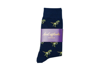 Navy blue socks with green dinosaur prints, offering the comfort of premium quality. Packaged with a purple label that reads "AusCufflinks AUSTRALIA," these T-Rex Socks are designed to bring joy to every step.