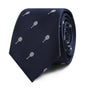 The Tennis Skinny Tie, featuring a rolled-up design in navy blue with small white tennis racket patterns, exudes athletic elegance and timeless refinement.