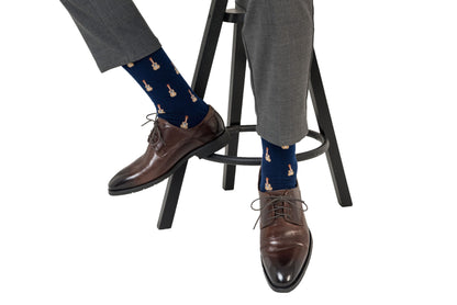 A person's legs and feet adorned with comfortable Guitar Socks and stylish shoes.