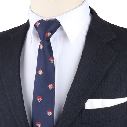 A mannequin dressed effortlessly in a dark pinstripe suit, white shirt, and the Gamer Face Skinny Tie adorned with small red and white patterns, featuring a folded white pocket square, perfect for those looking to level up their fashion game.