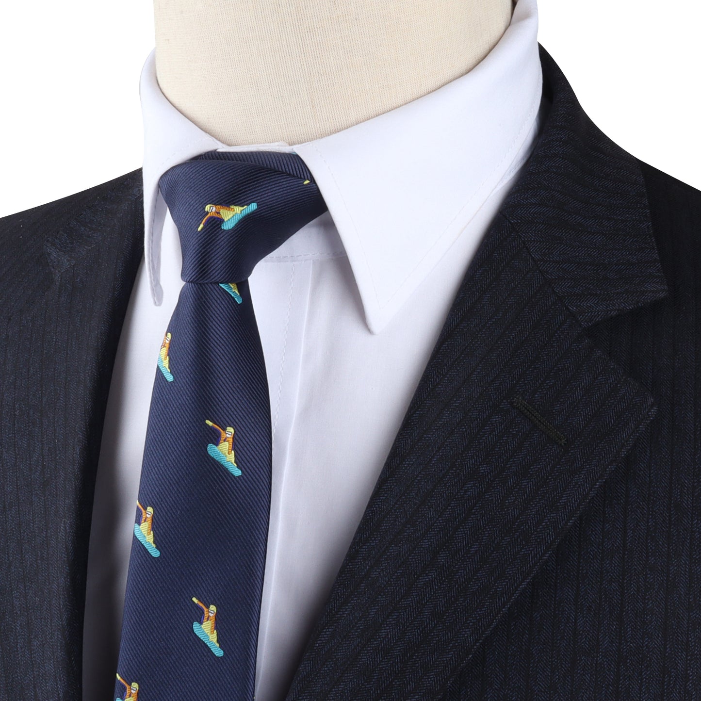 Close-up of a mannequin dressed in a dark pinstripe suit, white dress shirt, and a navy-blue tie featuring the Snowboarder Skinny Tie with a pattern of cartoon surfers dashing downhill.