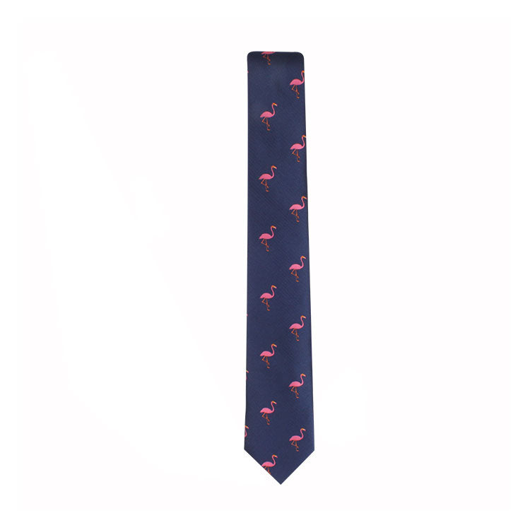 The Flamingo Skinny Tie is designed in navy blue with a whimsical touch, showcasing small pink flamingo patterns evenly spread across the tie.