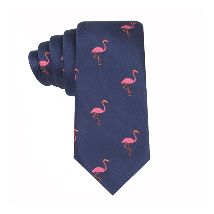 The Flamingo Skinny Tie captures a whimsical style with its navy blue hue and delightful flamingo pattern, providing a playful tribute to nature's beauty.