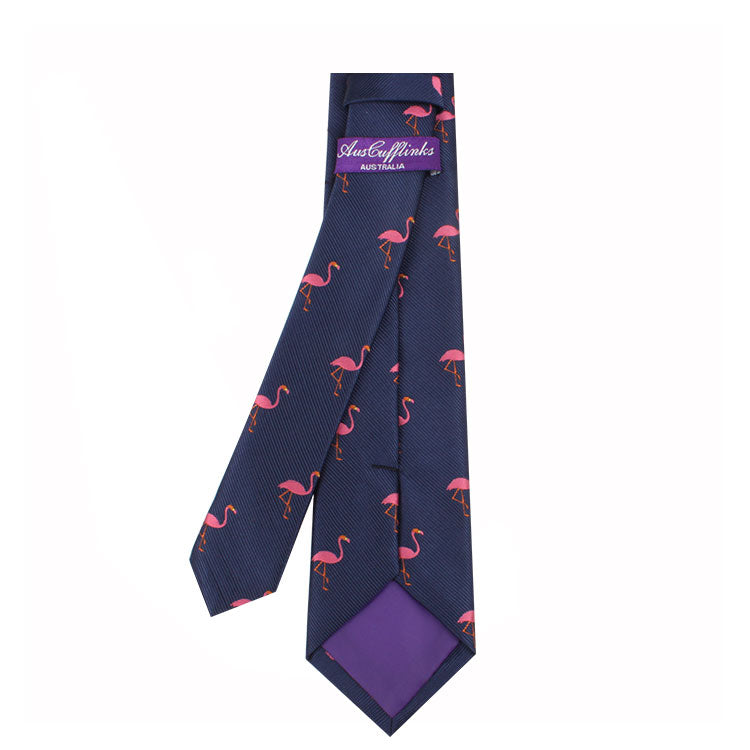 The Flamingo Skinny Tie features a whimsical style with its pink flamingo patterns set against a navy blue background and a luxurious purple lining.