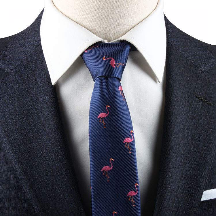 A person sporting a dark suit, white shirt, and the Flamingo Skinny Tie in blue.