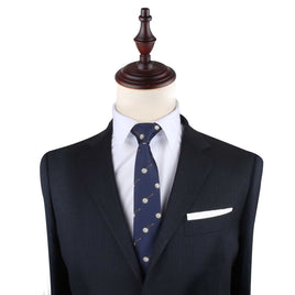 A blue suit with a Banjo Skinny Tie on a mannequin displaying sophistication.
