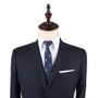 A mannequin exudes elegance, dressed in a dark suit, white shirt, and Crossed Baseball Skinny Tie, completed by a white pocket square—perfect for any occasion.