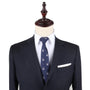 A mannequin exudes charming sophistication in a dark suit paired with a white shirt and the Bunny Skinny Tie. The ensemble is accented by a white pocket square, showcasing elegant clothing that speaks to sophisticated fashion.