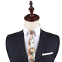 A mannequin showcasing a dark suit, white dress shirt, and a Floral Artisan Skinny Tie exemplifies Nature’s masterpiece through its dapper design.