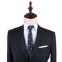 A mannequin dressed in a dark suit, white shirt, and the Classic Motorbike Skinny Tie, featuring a subtle navy pattern, exudes elegance.