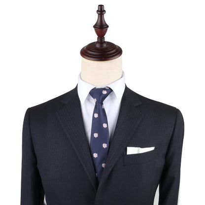 A mannequin dressed in a dark suit jacket, white dress shirt, and a Piggy Bank Skinny Tie showcases formal menswear, exuding sophistication. Perfect for those looking to invest in standout attire.