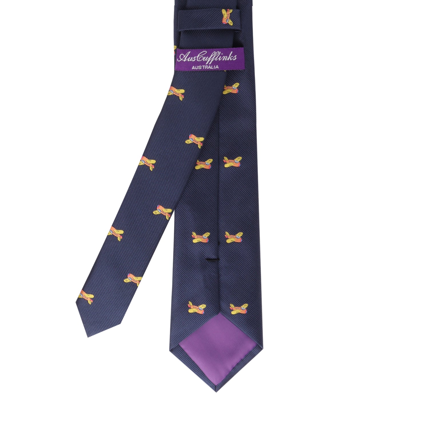 The "Orange Aircraft Skinny Tie," featuring small yellow and red abstract patterns on a navy blue background, a purple lining, and a branded tag that reads "Austin Marks Australia," exudes vibrant hues, elevating your style.