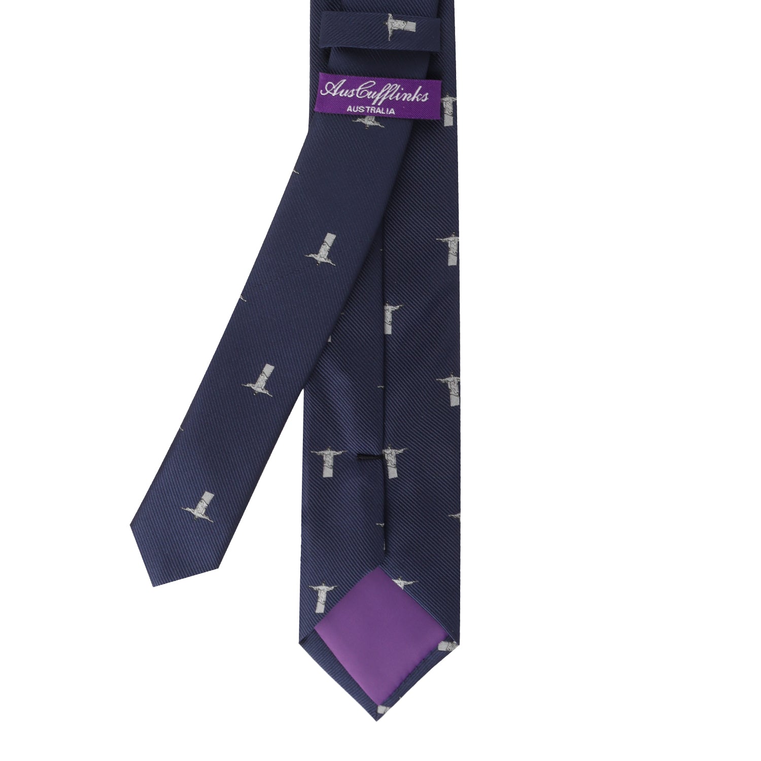 The Jesus Christ The Redeemer Skinny Tie, featuring a stylish navy blue design with a lighthouse pattern and a purple tip lining, embodies a timeless symbol of elegance.