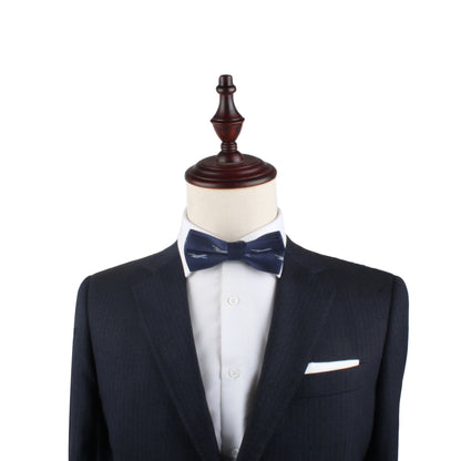 A high-fashion suit with an Aeroplane Bow Tie on a mannequin dummy.