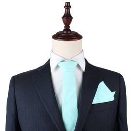 A mannequin showcasing a Aqua Skinny Necktie and Pocket Square Set in perfect harmony.