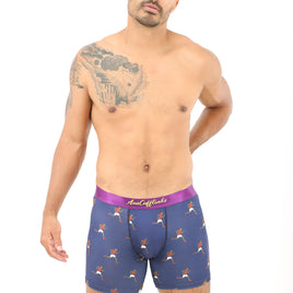 A man with a tattoo on his shoulder, radiating comfort in Athletics Boxer, stands against a white background.