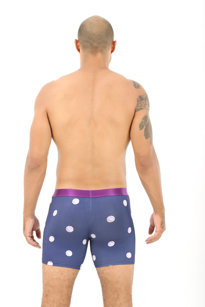 Wearing the Baseball Underwear, a person stands with their back to us, embodying the comfort of a favorite home run, highlighted by a striking tattoo on their shoulder.