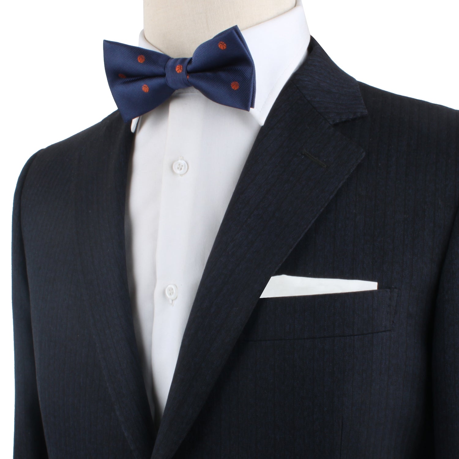 A mannequin wearing a Basketball Bow Tie and a suit, showcasing the latest fashion trends.