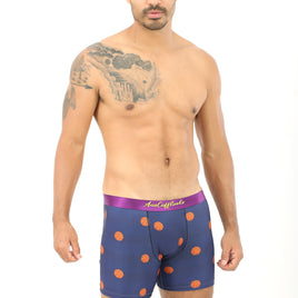 A person with a tattoo on their left shoulder is showcasing the Basketball Brief in front of a white background, embodying comfort as if prepared to hit the court in basketball shoes.