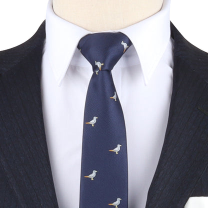 Close-up of a person wearing a dark suit jacket and a white dress shirt paired with the Seagul Skinny Tie, capturing a style that lets confidence soar.