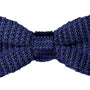 A black knit bow tie exudes a sense of relaxed sophistication against the crisp white background.