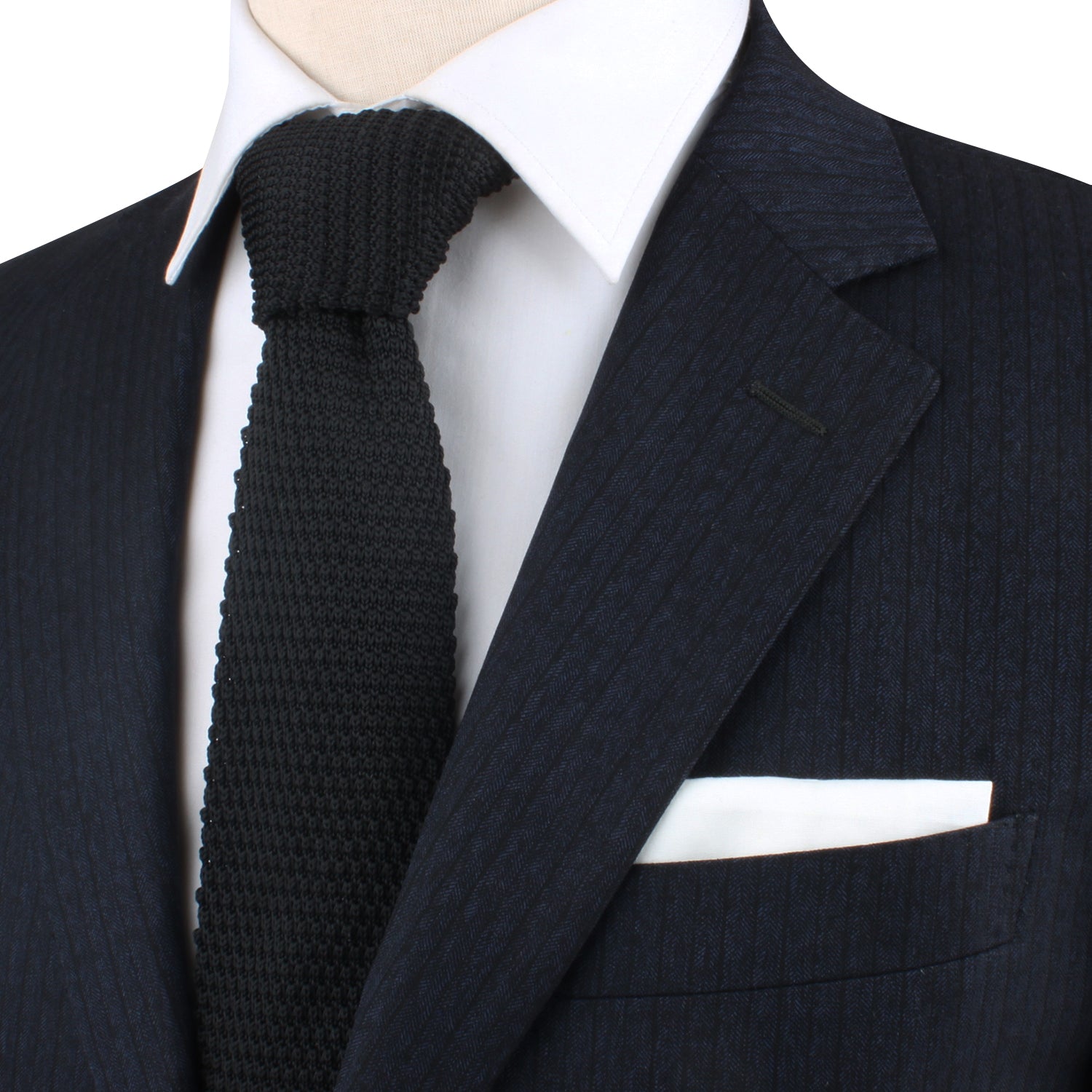A mannequin exuding classic charm in a Black Knitted Skinny Tie and suit.