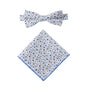 A matching set of a bow tie and pocket square, featuring a sophisticated black and light blue floral design on white cotton.