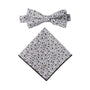 Black Print Floral Cotton Bow Tie & Pocket Square Set featuring an elegant design of blue and sleek black flowers on a crisp white background.