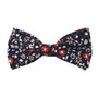 A fiery Black Red Orange Amaryllis floral bow tie with red and white flowers.