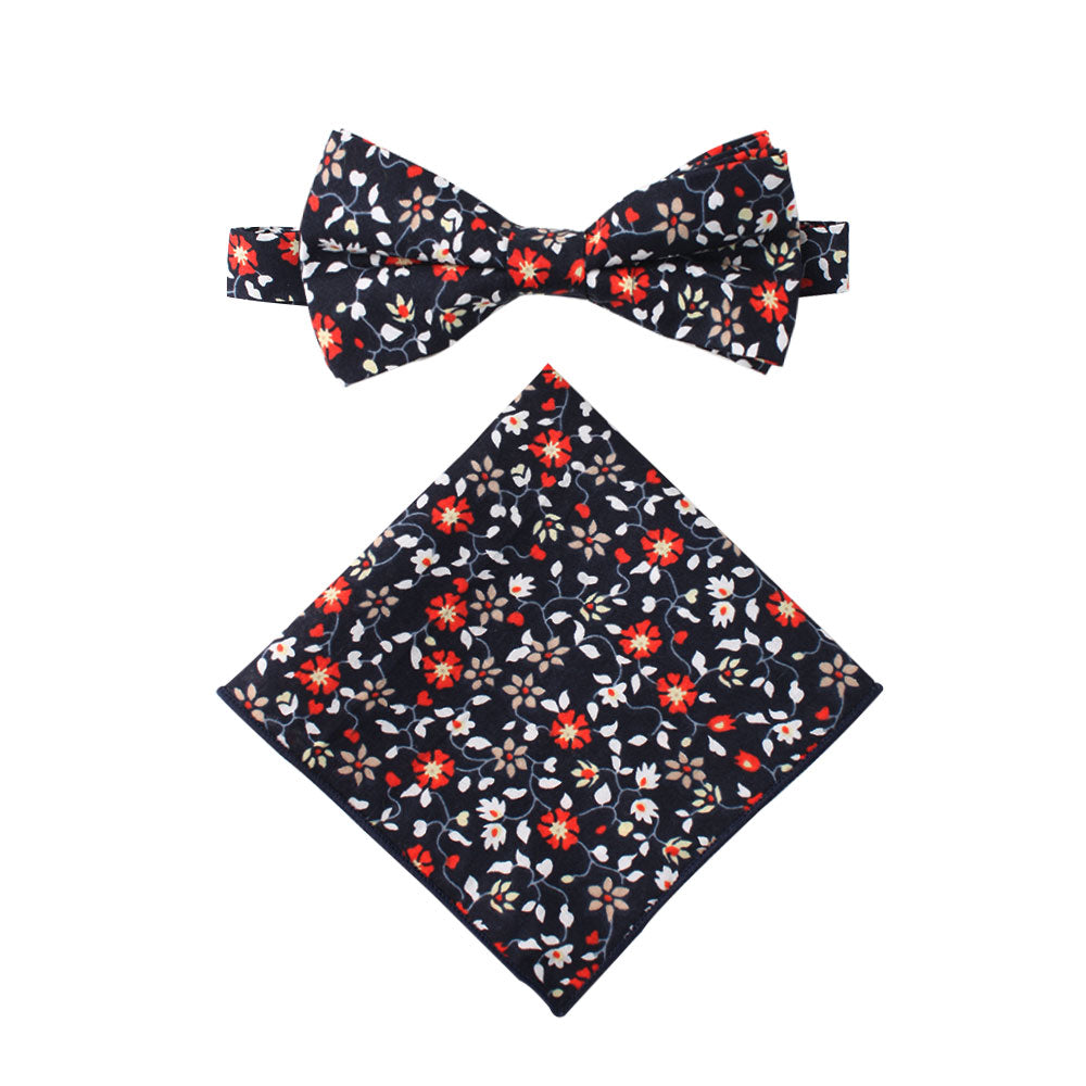 A coordinating bow tie and pocket square set featuring a black background, embellished with striking red, orange, and amaryllis flowers in cotton fabric—ideal for the stylish gentleman.