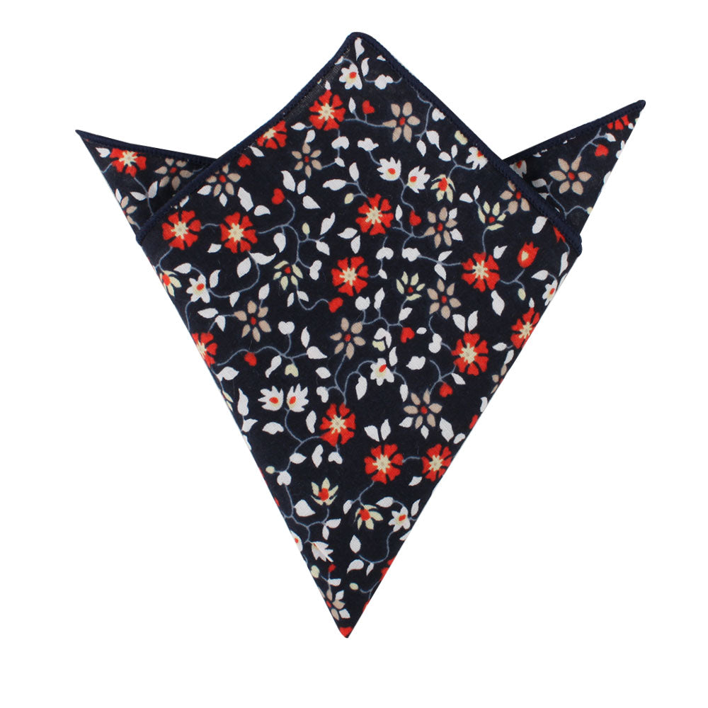 A sophisticated pocket square from the Black Red Orange Amaryllis Floral Cotton collection, showcasing striking red, white, and gray amaryllis flowers and leaves set against a navy blue backdrop. It's elegantly folded with two pointed ends at the top—ideal for the refined gentleman.