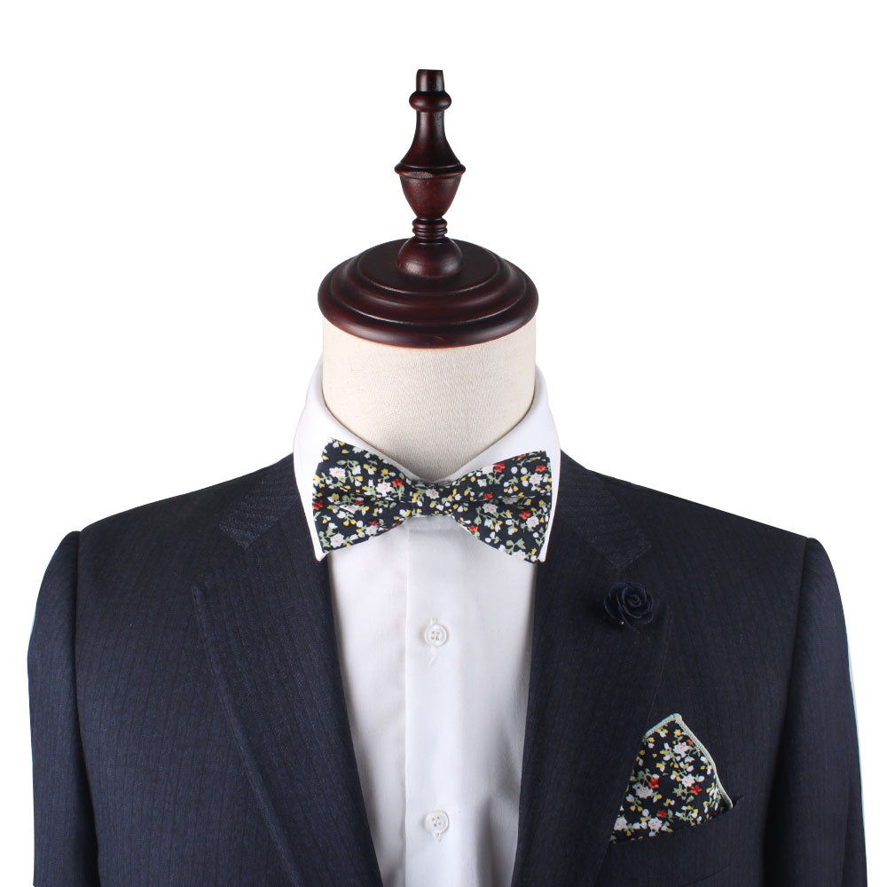 A Black Red Yellow Multi Floral Cotton bow tie on a mannequin.