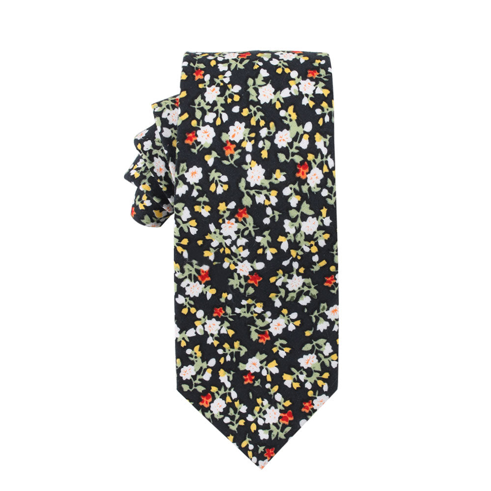 The Multi Floral Skinny Cotton Tie, adorned with red, white, and yellow floral patterns on a black background, exudes pastel sophistication and adds a touch of business finesse to any formal ensemble.