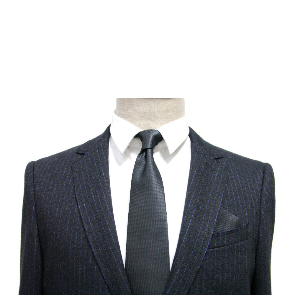 A suit and tie on a mannequin exude impeccable elegance, showcasing the Black Business Tie & Pocket Square Set as the epitome of formality.